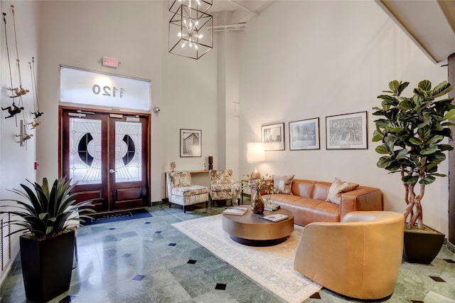 interior space featuring a high ceiling and a chandelier