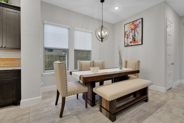 dining room with recessed lighting, baseboards, and an inviting chandelier