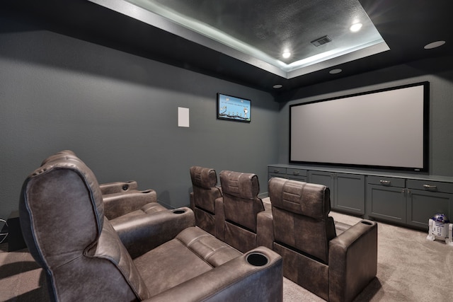 home theater with recessed lighting, visible vents, a raised ceiling, and light colored carpet