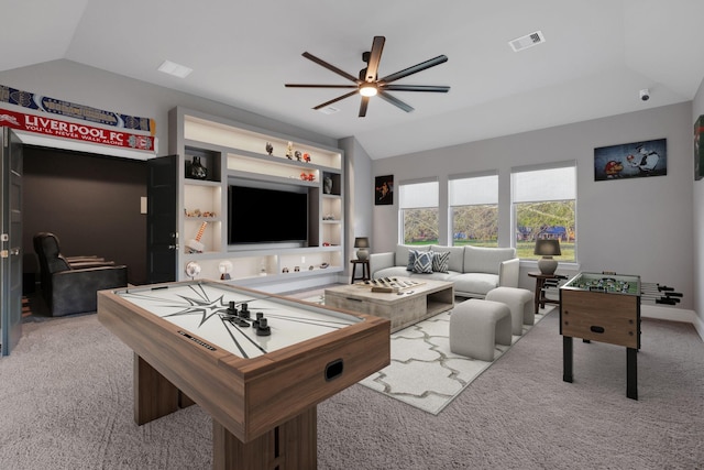 rec room with visible vents, built in features, ceiling fan, carpet, and vaulted ceiling