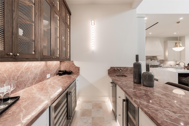 bar with premium range hood, wine cooler, wet bar, and decorative backsplash