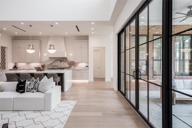 living area with recessed lighting and light wood-style flooring