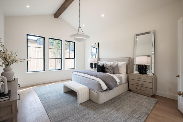 bedroom featuring recessed lighting, beam ceiling, baseboards, and light wood finished floors