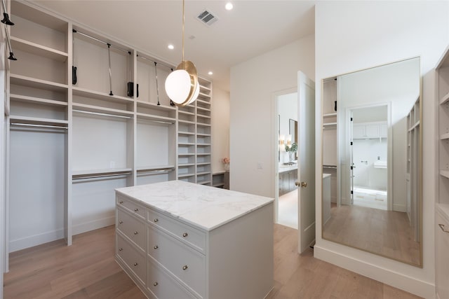 walk in closet featuring light wood-style flooring and visible vents