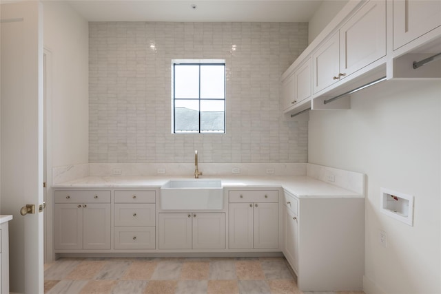 washroom featuring a sink, cabinet space, and hookup for a washing machine