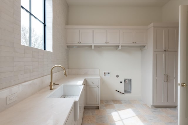 clothes washing area with washer hookup, cabinet space, and electric dryer hookup