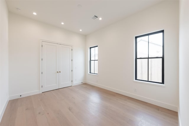 spare room with baseboards, recessed lighting, visible vents, and light wood-style floors