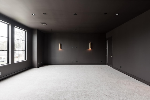 empty room with carpet floors and visible vents