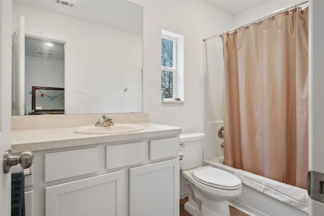 bathroom with shower / bath combo, visible vents, vanity, and toilet