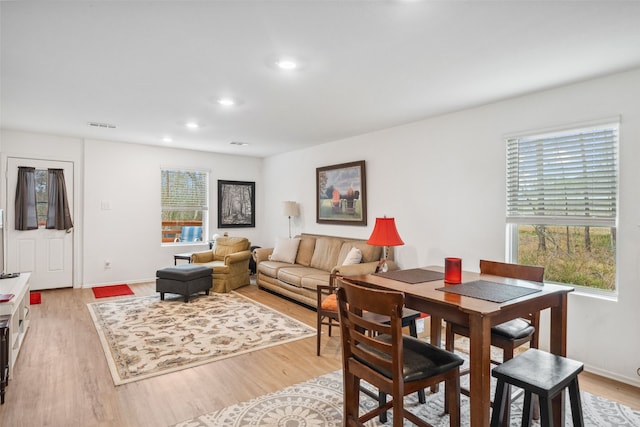 dining room featuring baseboards, recessed lighting, visible vents, and light wood-style floors