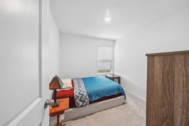 bedroom featuring carpet and baseboards