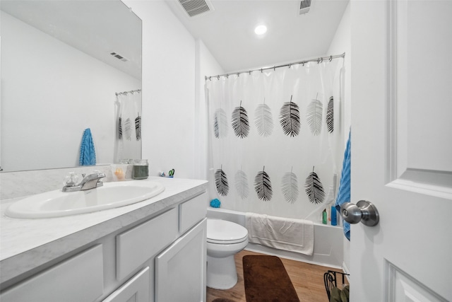 full bathroom featuring visible vents, vanity, toilet, and wood finished floors