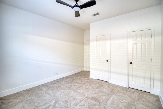 unfurnished bedroom featuring a ceiling fan, visible vents, and baseboards