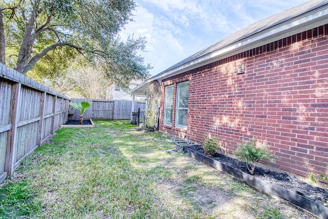 view of yard with a fenced backyard