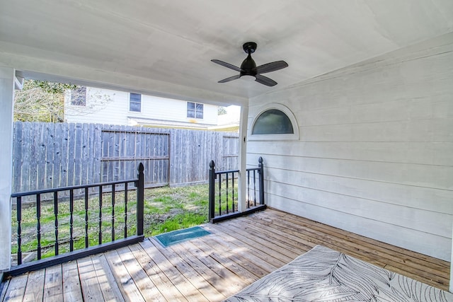 wooden deck with a ceiling fan and fence