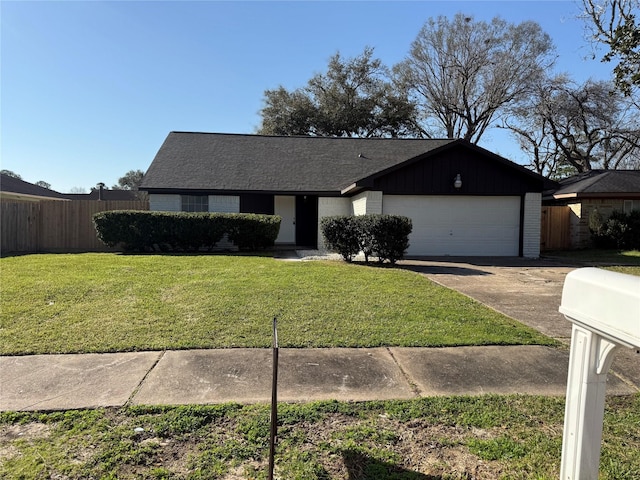 view of front of property with brick siding, fence, concrete driveway, and a front yard