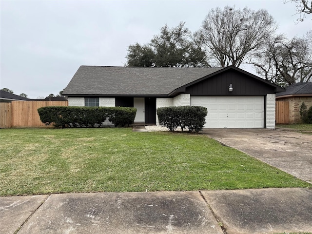 view of front of property with a garage, brick siding, fence, driveway, and a front yard