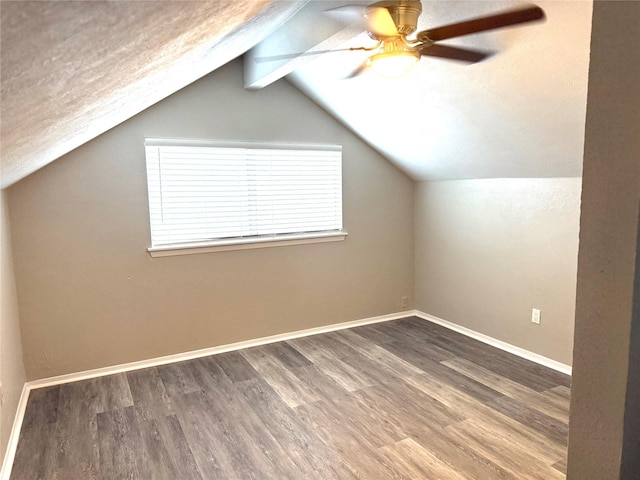 bonus room with vaulted ceiling with beams, a ceiling fan, baseboards, and wood finished floors