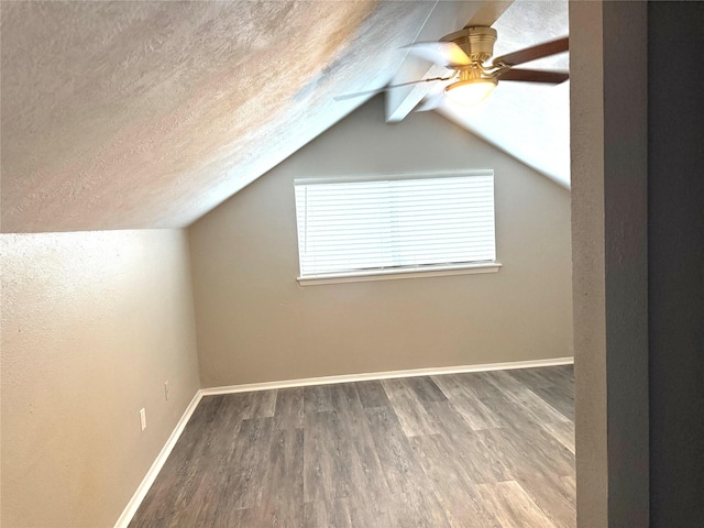 bonus room with lofted ceiling with beams, a textured ceiling, and wood finished floors