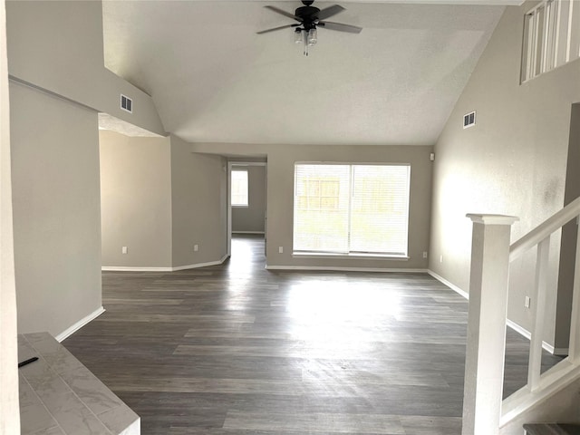 unfurnished living room with a ceiling fan, visible vents, baseboards, stairway, and dark wood finished floors