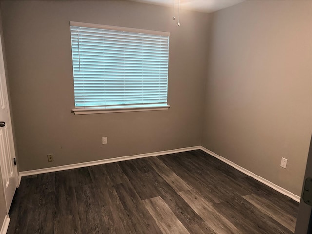 unfurnished room featuring wood finished floors and baseboards