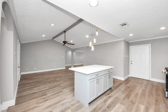 kitchen featuring arched walkways, light wood finished floors, lofted ceiling with beams, ceiling fan, and baseboards