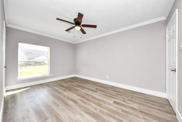 unfurnished room with crown molding, wood finished floors, a ceiling fan, and baseboards