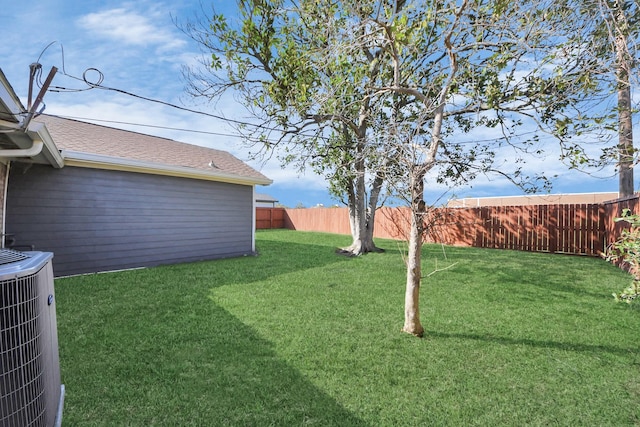 view of yard featuring a fenced backyard and central AC unit