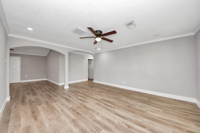 unfurnished room featuring light wood-style floors, arched walkways, visible vents, and ceiling fan