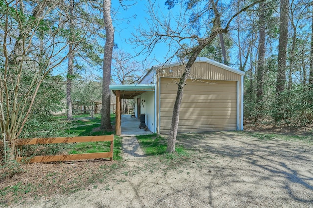 exterior space featuring a detached garage and driveway