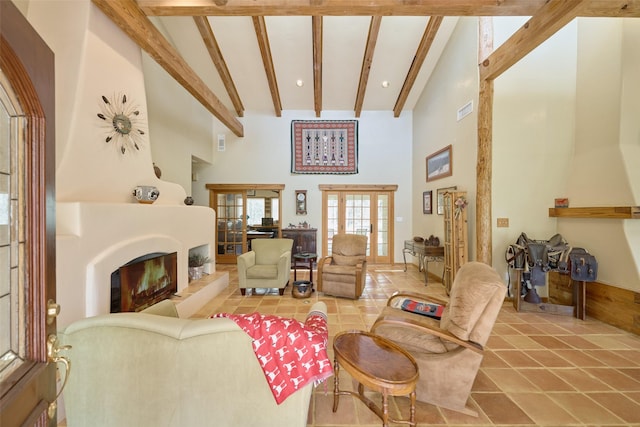 tiled living area featuring visible vents, a large fireplace, a high ceiling, and beam ceiling