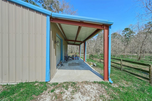 view of parking / parking lot featuring fence