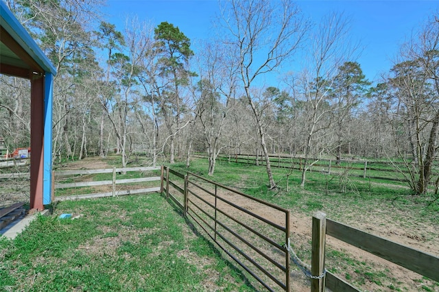 view of yard featuring a rural view and fence