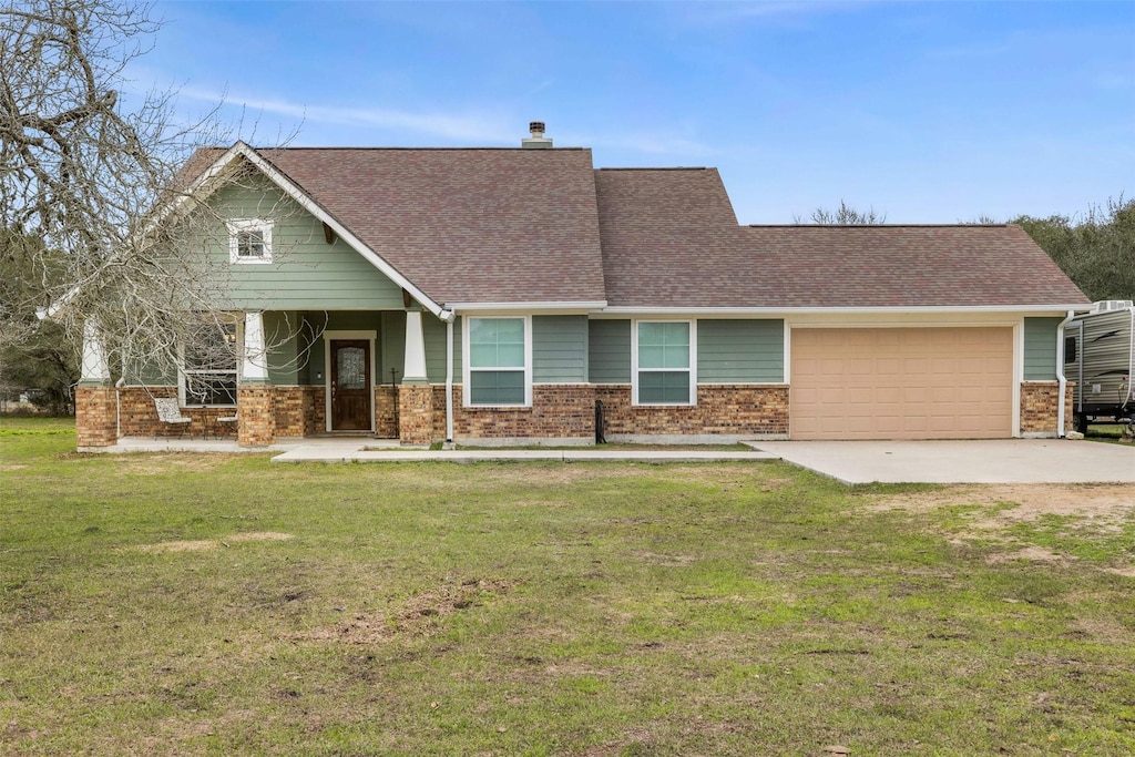 1065 Hoffman Ln, Alleyton, TX 78935 - view of front of house with brick siding, a chimney, an attached garage, driveway, and a front lawn