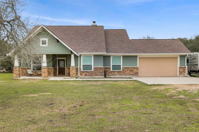 view of front of house with brick siding, a chimney, an attached garage, driveway, and a front lawn