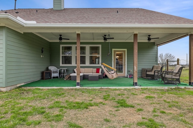 rear view of property with roof with shingles, a chimney, a lawn, an outdoor hangout area, and a patio area