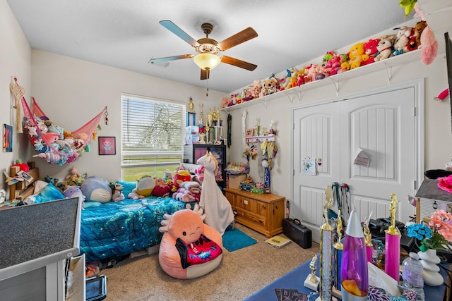 bedroom featuring ceiling fan, carpet floors, and a closet