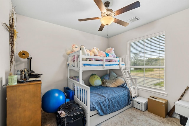 carpeted bedroom with visible vents and a ceiling fan