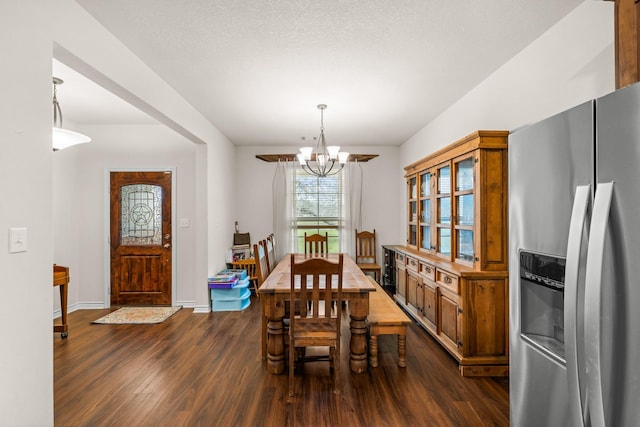 dining space featuring baseboards, a chandelier, and dark wood-style flooring