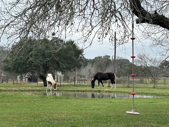 view of home's community featuring fence and a yard