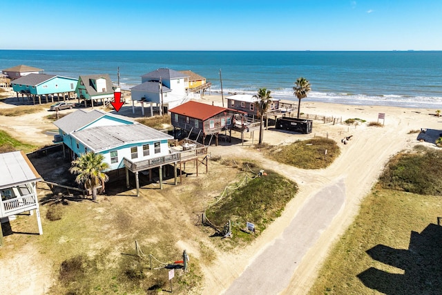 drone / aerial view with a beach view and a water view