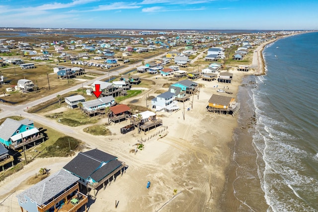 bird's eye view featuring a water view and a view of the beach