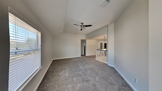 unfurnished living room with visible vents, baseboards, a ceiling fan, carpet, and vaulted ceiling