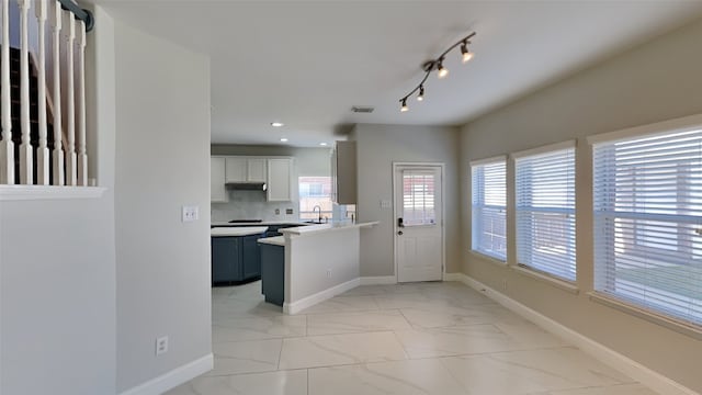 kitchen with marble finish floor, baseboards, and visible vents