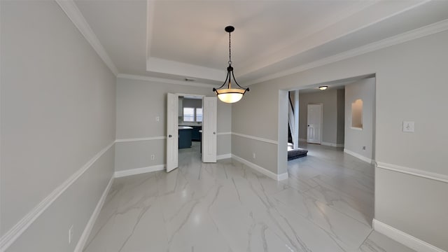 unfurnished dining area with a tray ceiling, marble finish floor, and baseboards