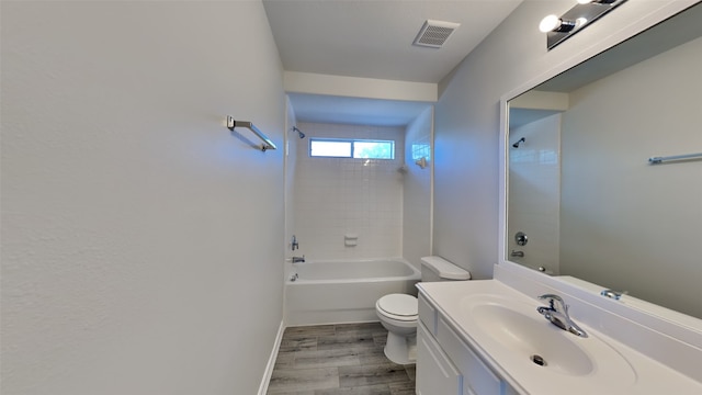 bathroom with visible vents, toilet, wood finished floors, bathtub / shower combination, and vanity