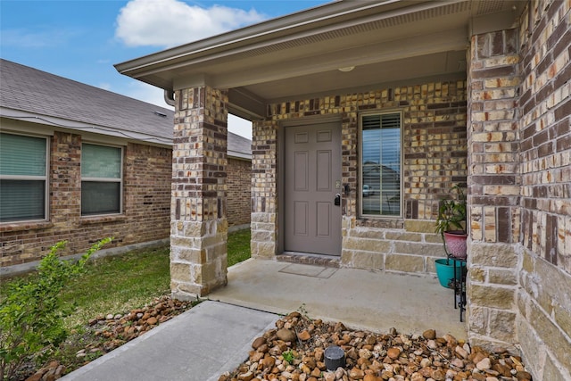 view of exterior entry with brick siding