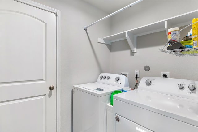 clothes washing area featuring laundry area and washing machine and clothes dryer