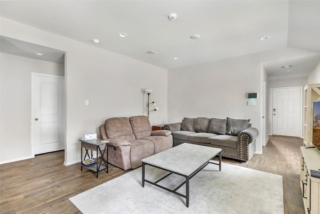 living room featuring light wood-style flooring, visible vents, baseboards, and recessed lighting