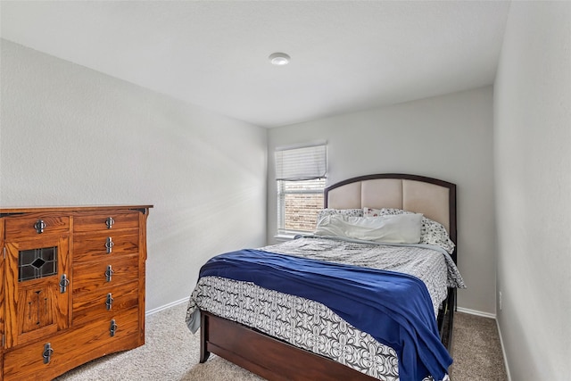 carpeted bedroom featuring baseboards